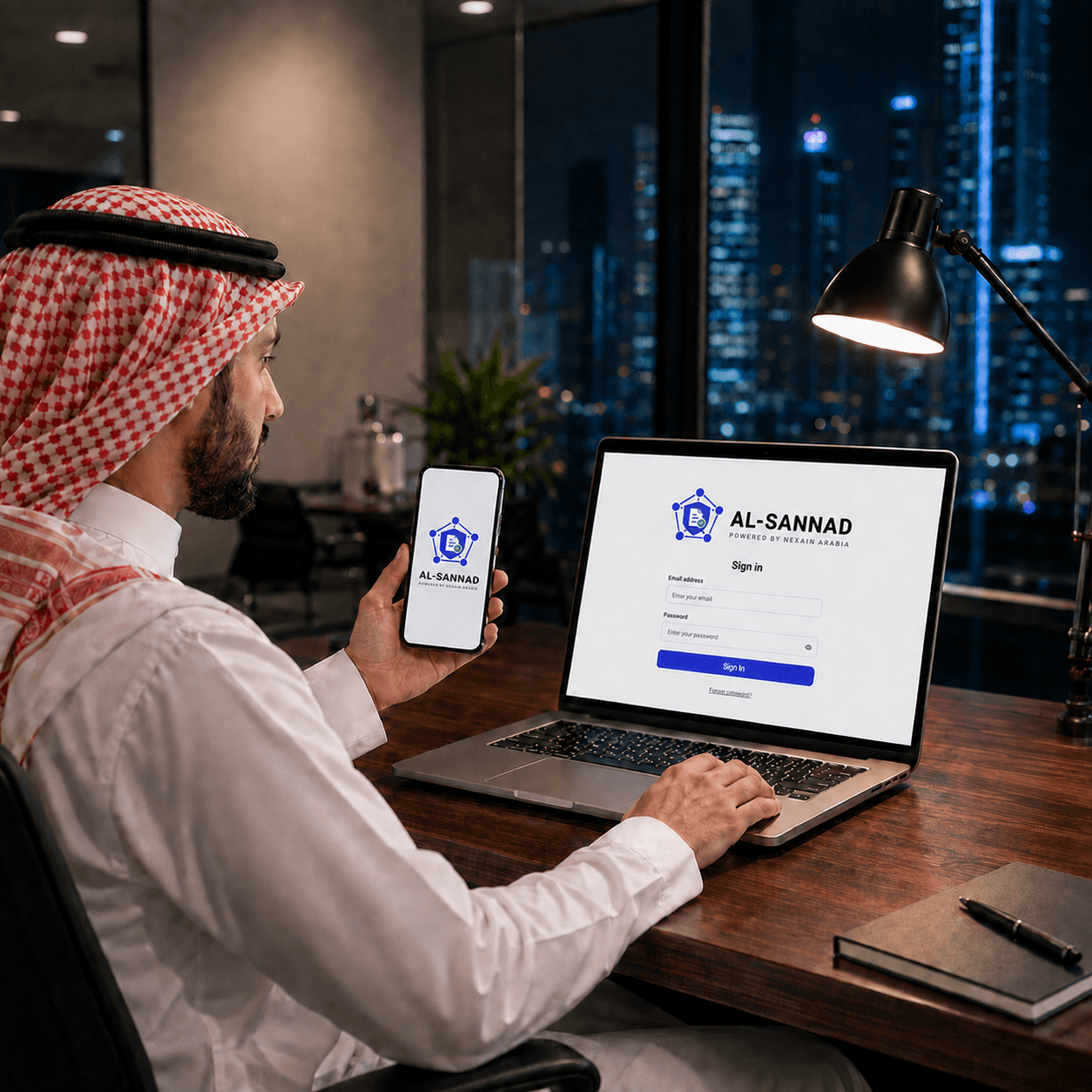 Al Sannad office workspace with mobile and laptop access screens.